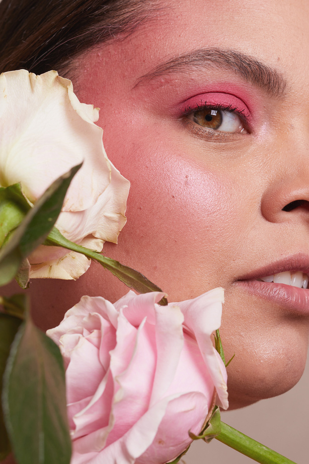 Curvy Woman with Bold Makeup and Flowers