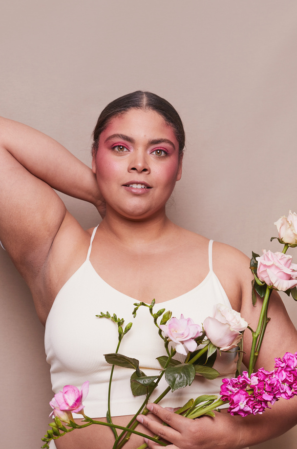 Curvy Woman with Bold Makeup and Flowers